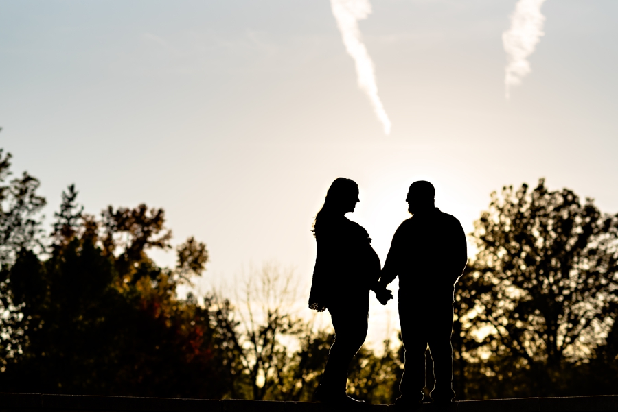 A silhouette of a pregnant couple during their engagement session in valley forge state park.